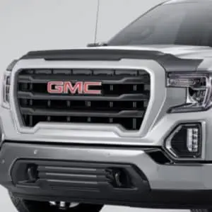 Genuine GM hood deflector fitted above the grille of a silver GMC truck