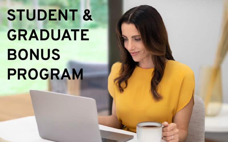 Woman working at a laptop with a cup of coffee, under the words Student & Graduate Bonus Program